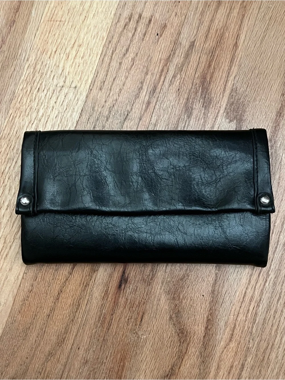 Black Fold-Over Clutch Wallet new without tags. Never used. Genuine leather